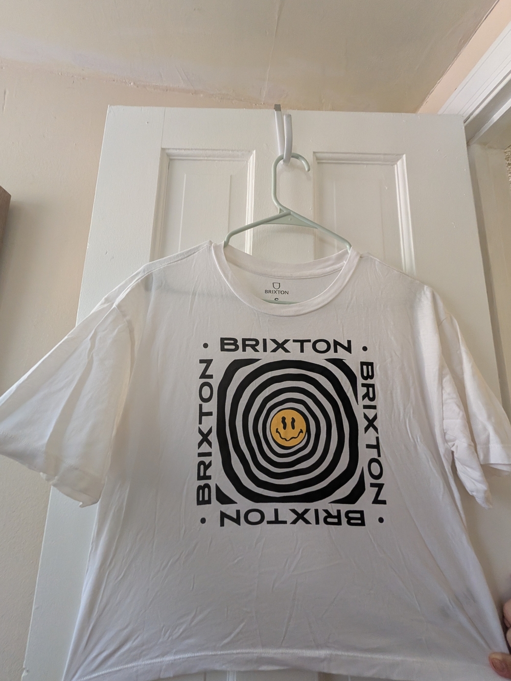 Brixton White Tee with Black Spiral Graphic and Yellow Smile